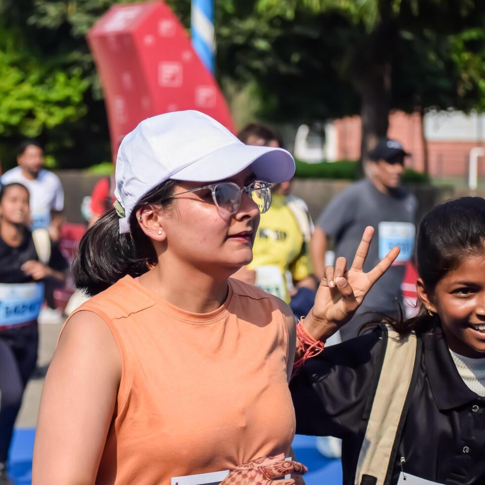 New Delhi, India - July 15 2024 - Vedanta Delhi Half Marathon race after covid in which marathon participants about to cross the finish line, Delhi Half Marathon 2023 photo