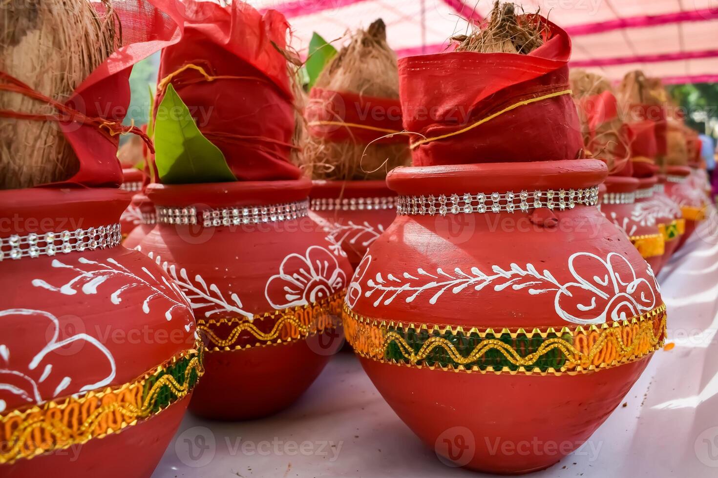 Kalash with coconut and mango leaf with floral decoration earthen pots containing sacred water. Kalash for hindu puja during Jagannath Temple Mangal Kalash Yatra, front view, closeup photo