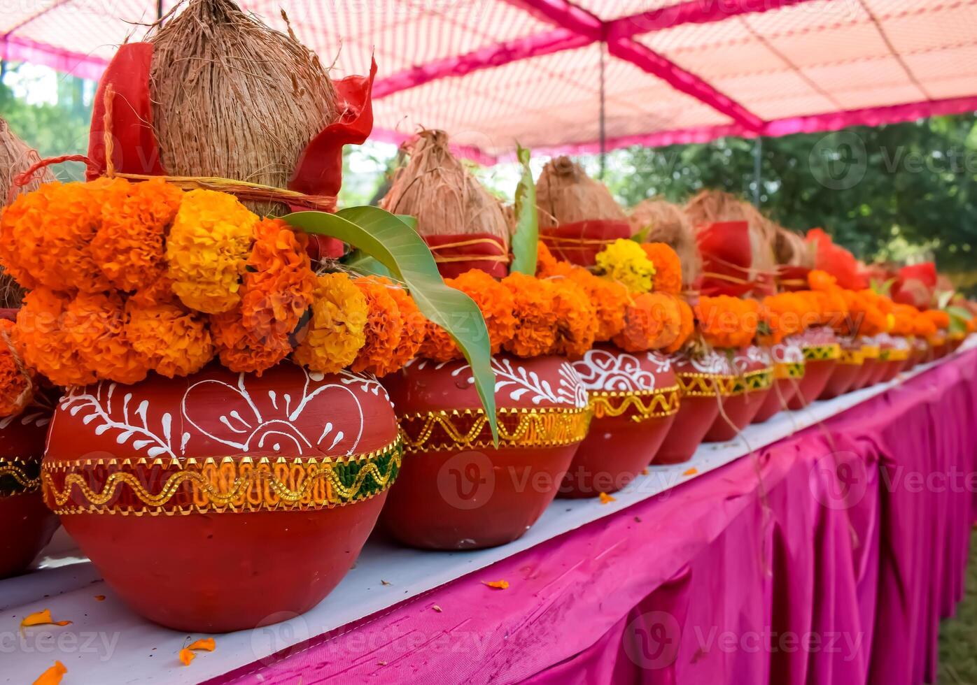 Kalash with coconut and mango leaf with floral decoration earthen pots containing sacred water. Kalash for hindu puja during Jagannath Temple Mangal Kalash Yatra, front view, closeup photo