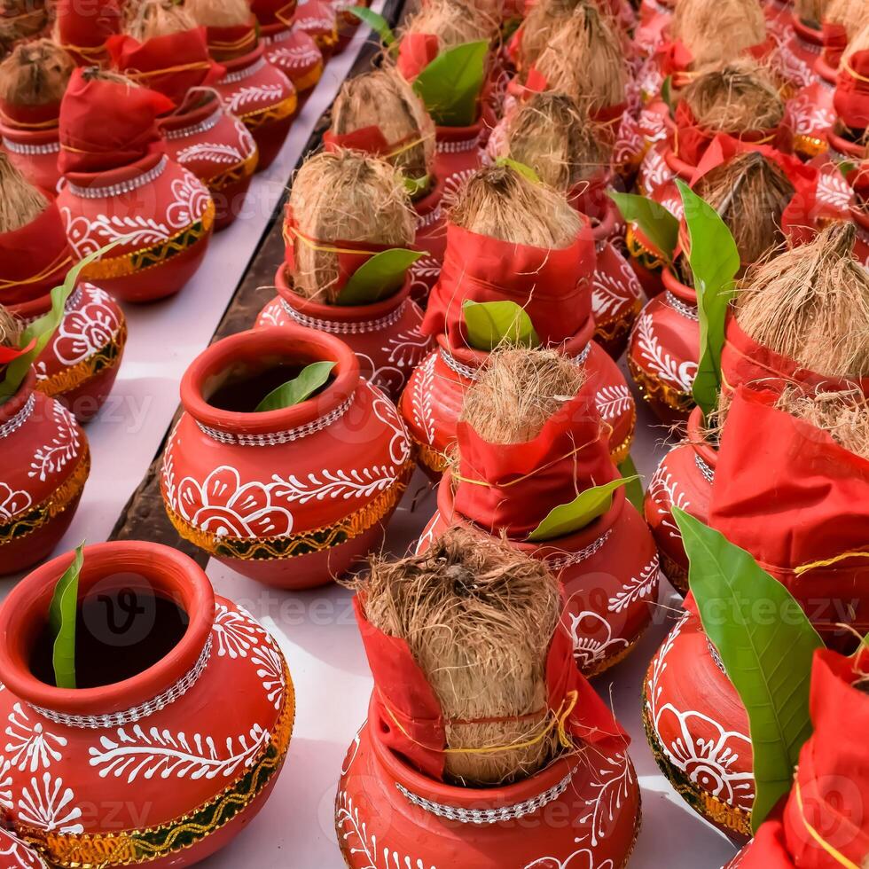 Kalash with coconut and mango leaf with floral decoration earthen pots containing sacred water. Kalash for hindu puja during Jagannath Temple Mangal Kalash Yatra, front view, closeup photo
