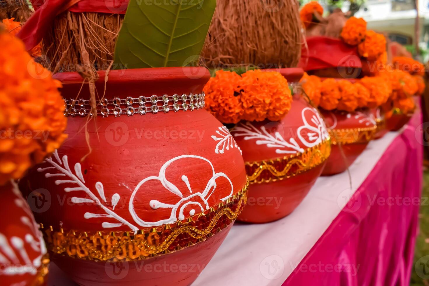 Kalash with coconut and mango leaf with floral decoration earthen pots containing sacred water. Kalash for hindu puja during Jagannath Temple Mangal Kalash Yatra, front view, closeup photo
