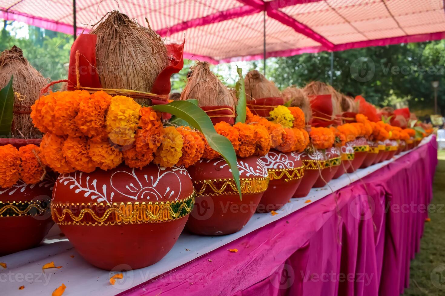 Kalash with coconut and mango leaf with floral decoration earthen pots containing sacred water. Kalash for hindu puja during Jagannath Temple Mangal Kalash Yatra, front view, closeup photo
