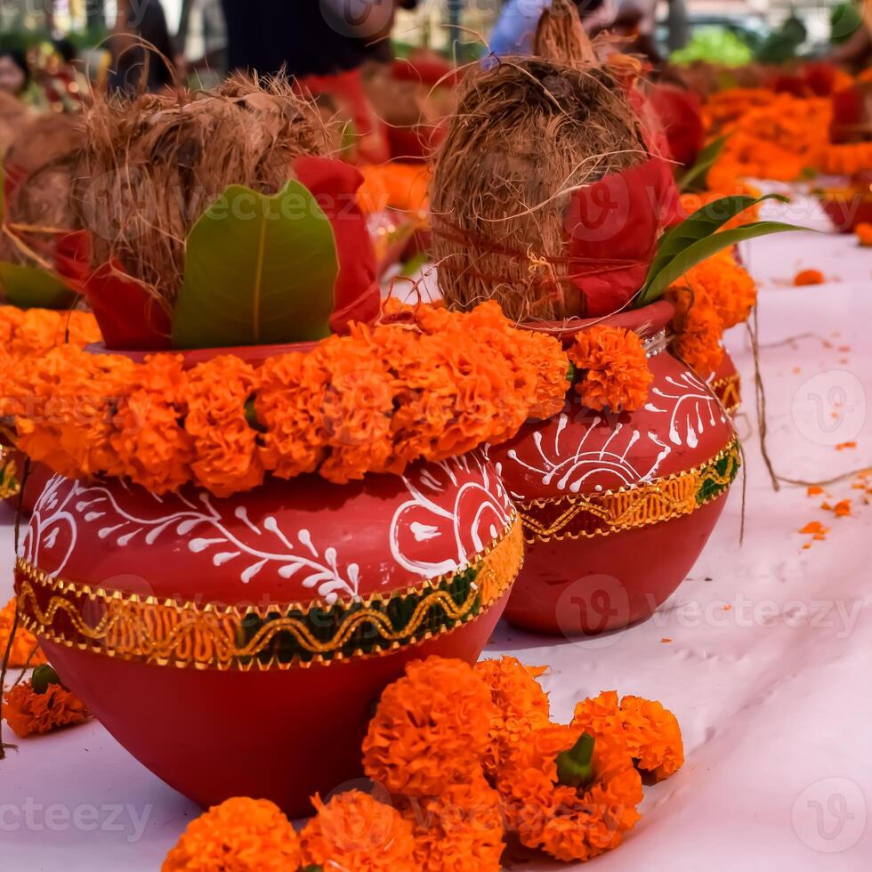 Kalash with coconut and mango leaf with floral decoration earthen pots containing sacred water. Kalash for hindu puja during Jagannath Temple Mangal Kalash Yatra, front view, closeup photo