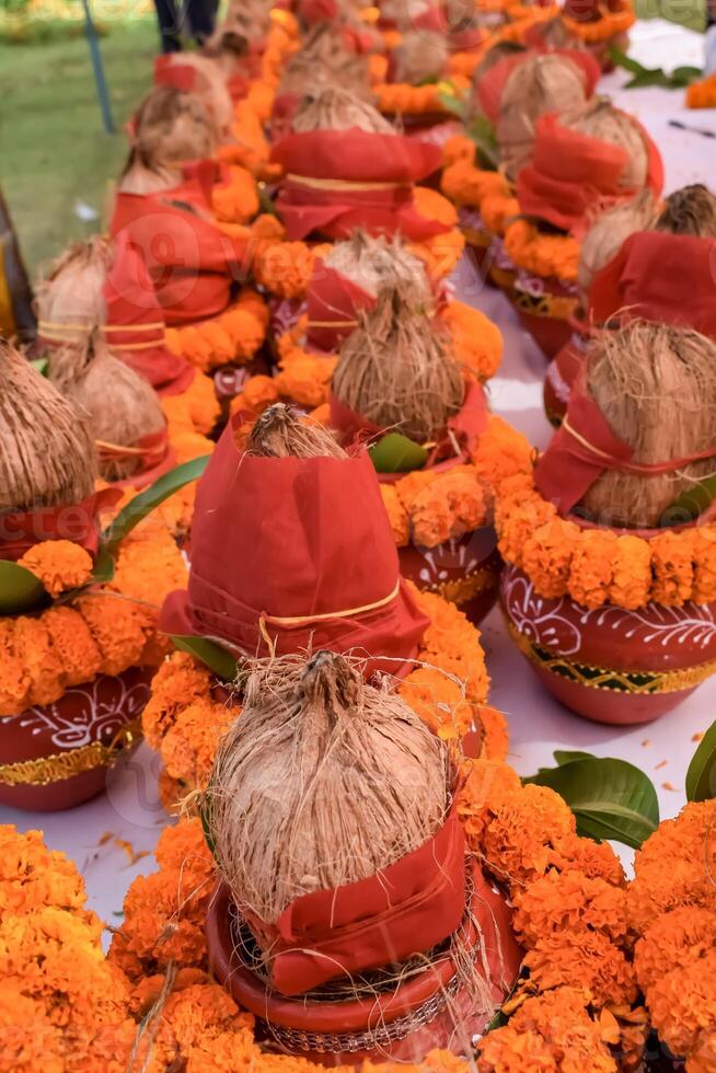 Kalash with coconut and mango leaf with floral decoration earthen pots containing sacred water. Kalash for hindu puja during Jagannath Temple Mangal Kalash Yatra, front view, closeup photo