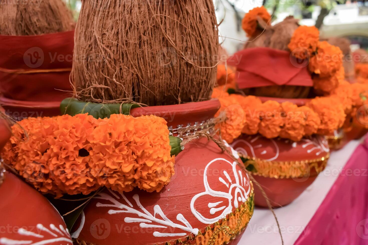 Kalash with coconut and mango leaf with floral decoration earthen pots containing sacred water. Kalash for hindu puja during Jagannath Temple Mangal Kalash Yatra, front view, closeup photo