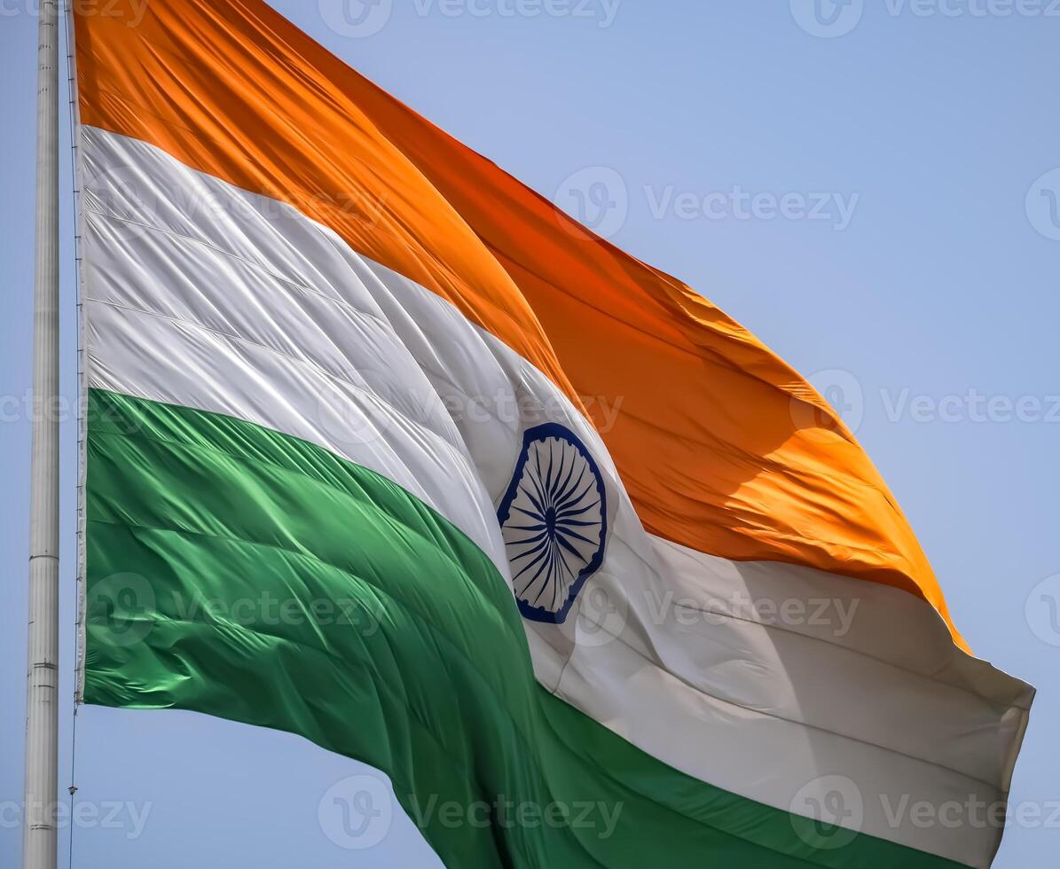 India flag flying high at Connaught Place with pride in blue sky, India flag fluttering, Indian Flag on Independence Day and Republic Day of India, tilt up shot, Waving Indian flag, Har Ghar Tiranga photo