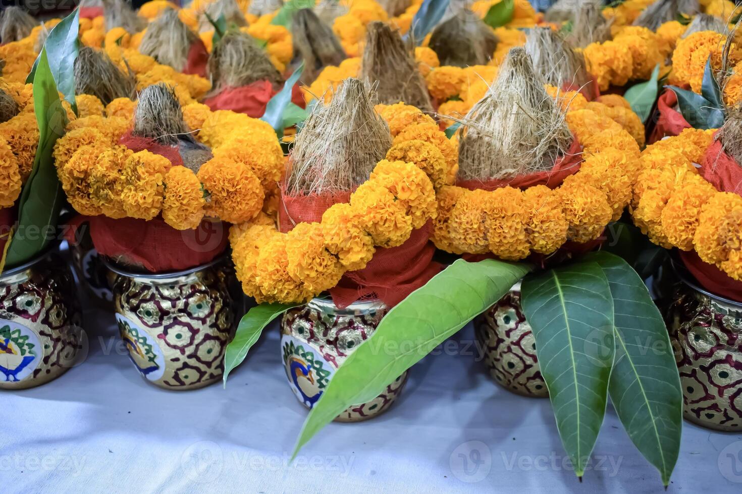 Kalash with coconut and mango leaf with floral decoration earthen pots containing sacred water. Kalash for hindu puja during Jagannath Temple Mangal Kalash Yatra, front view, closeup photo