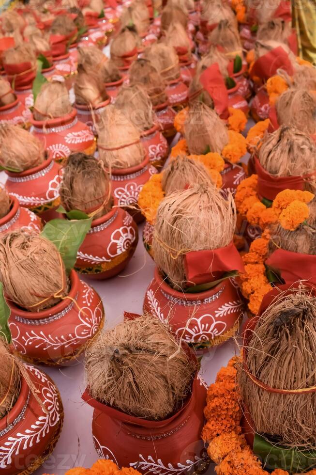 Kalash with coconut and mango leaf with floral decoration earthen pots containing sacred water. Kalash for hindu puja during Jagannath Temple Mangal Kalash Yatra, front view, closeup photo