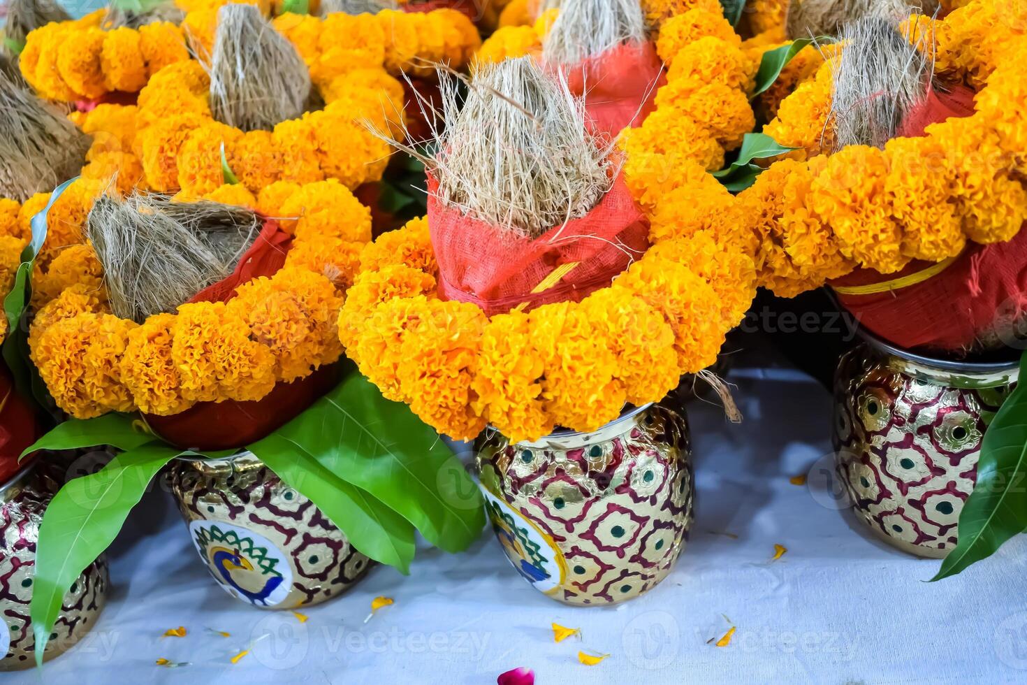 Kalash with coconut and mango leaf with floral decoration earthen pots containing sacred water. Kalash for hindu puja during Jagannath Temple Mangal Kalash Yatra, front view, closeup photo