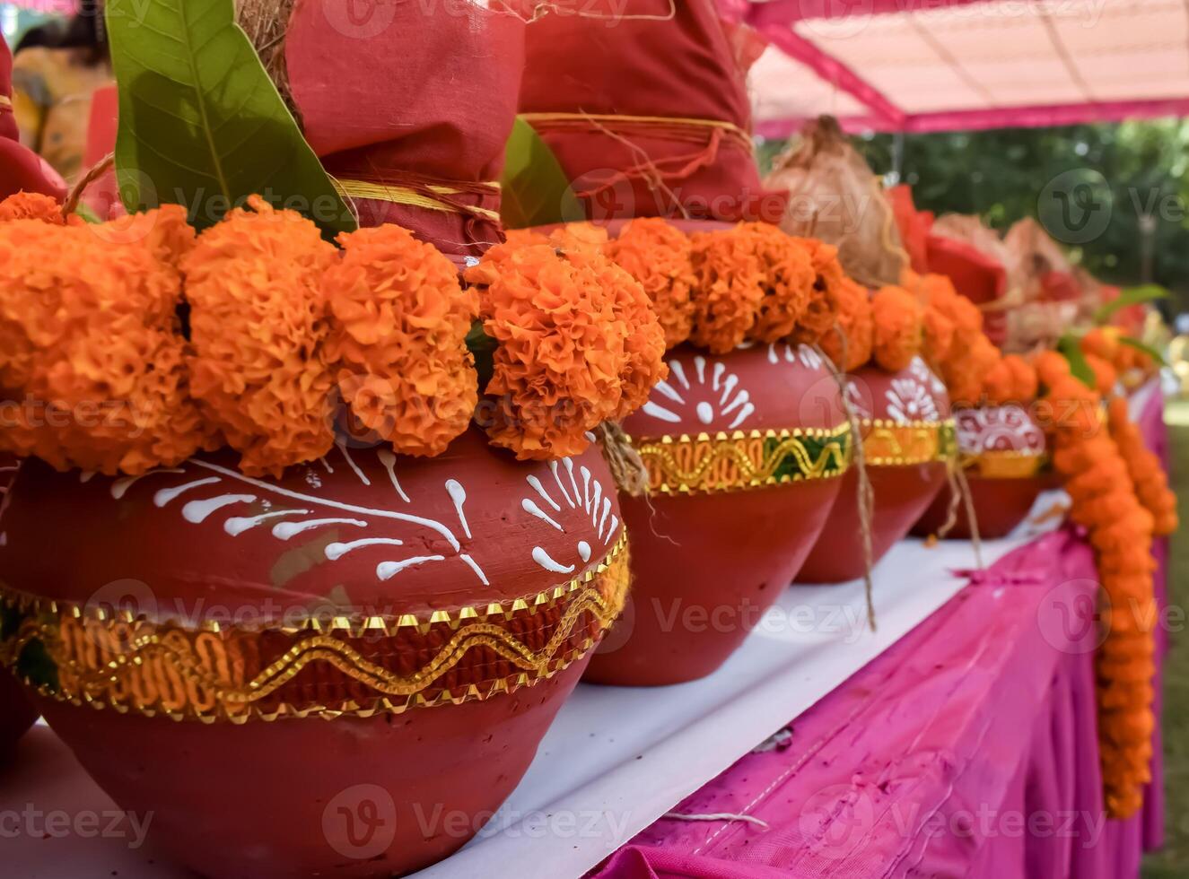 Kalash with coconut and mango leaf with floral decoration earthen pots containing sacred water. Kalash for hindu puja during Jagannath Temple Mangal Kalash Yatra, front view, closeup photo