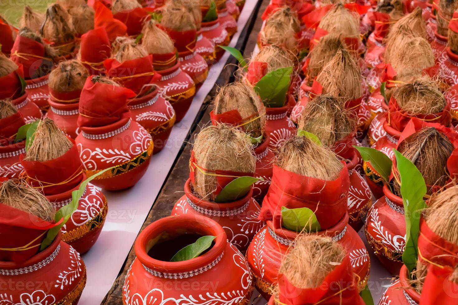 Kalash with coconut and mango leaf with floral decoration earthen pots containing sacred water. Kalash for hindu puja during Jagannath Temple Mangal Kalash Yatra, front view, closeup photo