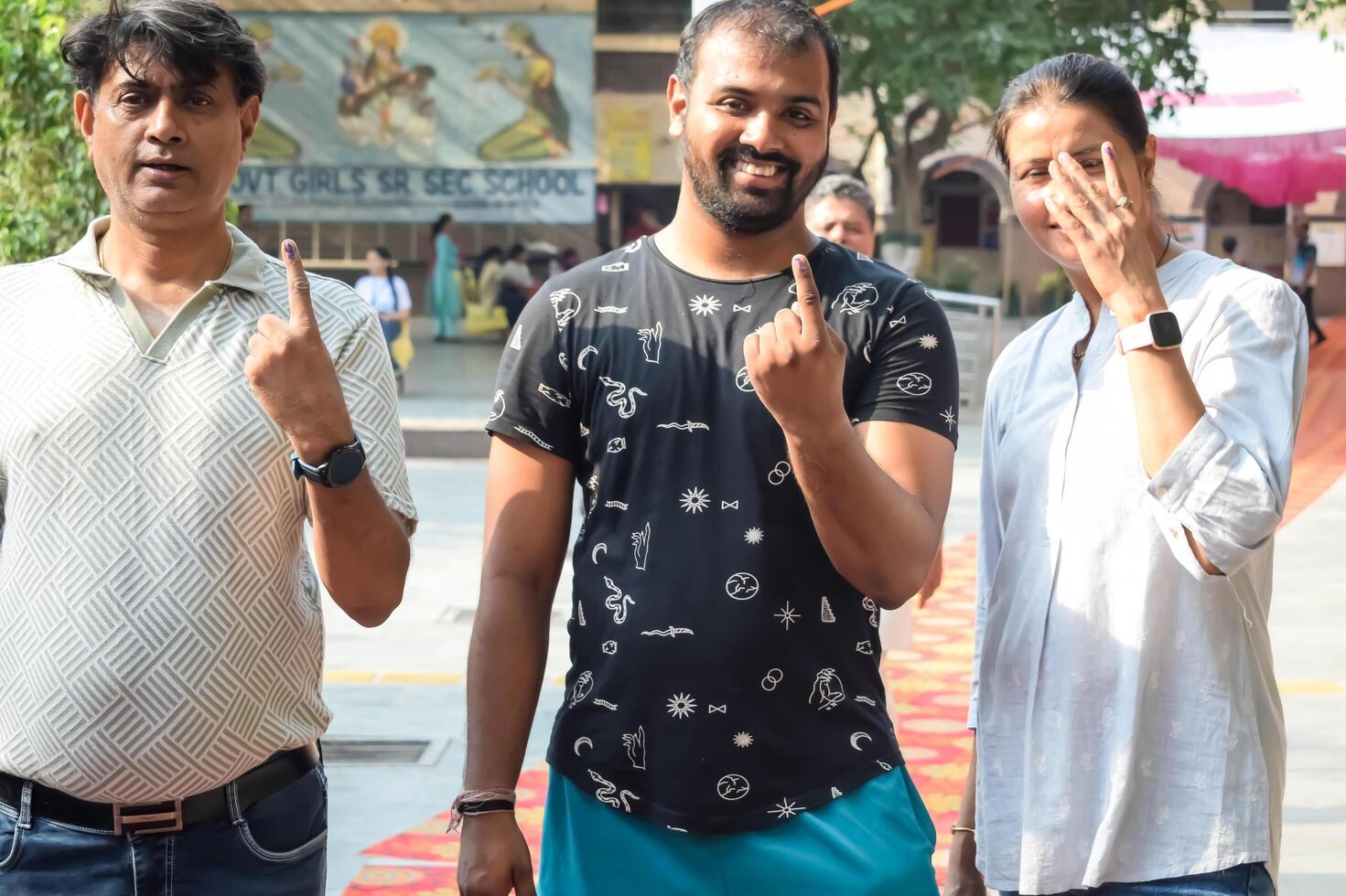 New Delhi, India - May 25 2024 - Unidentified people showing their ink-marked fingers after casting votes in front of polling booth of east Delhi area for general Lok Sabha Elections 2024 photo