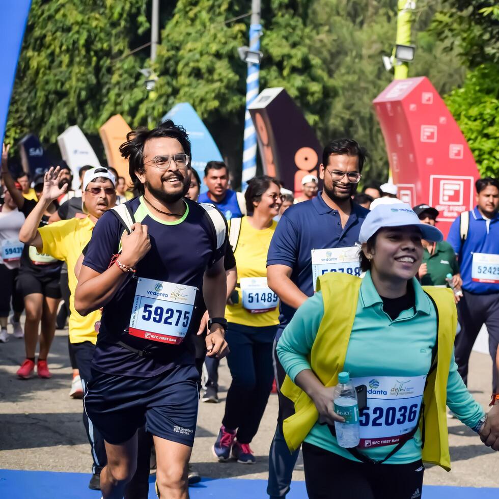 New Delhi, India - July 15 2024 - Vedanta Delhi Half Marathon race after covid in which marathon participants about to cross the finish line, Delhi Half Marathon 2023 photo