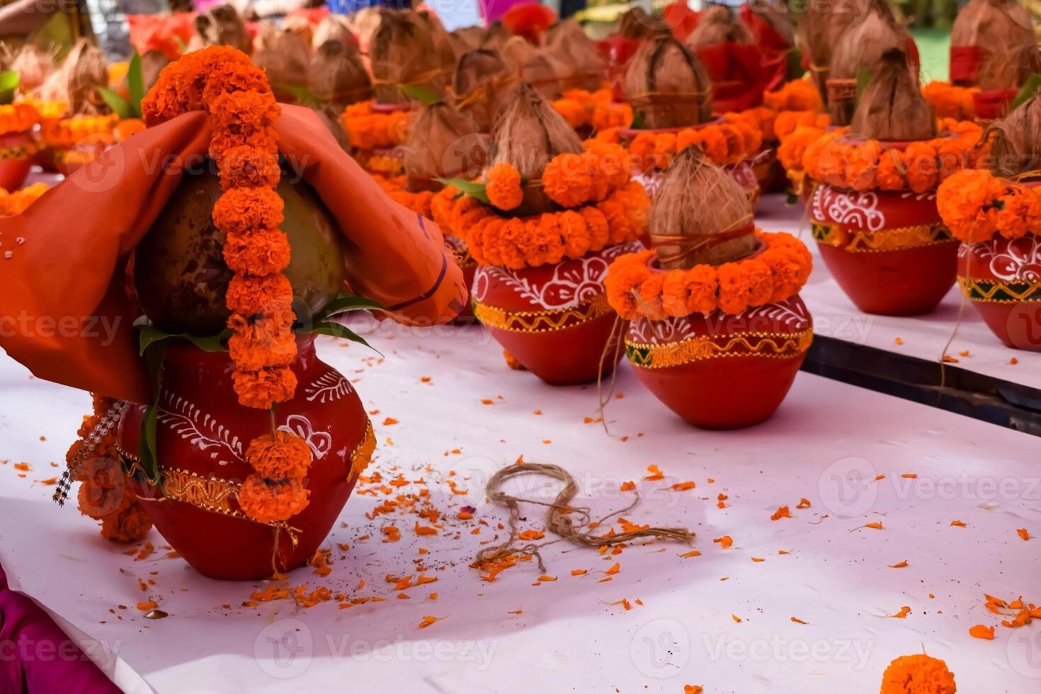 Kalash with coconut and mango leaf with floral decoration earthen pots containing sacred water. Kalash for hindu puja during Jagannath Temple Mangal Kalash Yatra, front view, closeup photo