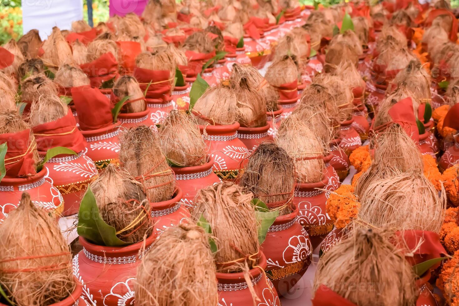 Kalash with coconut and mango leaf with floral decoration earthen pots containing sacred water. Kalash for hindu puja during Jagannath Temple Mangal Kalash Yatra, front view, closeup photo