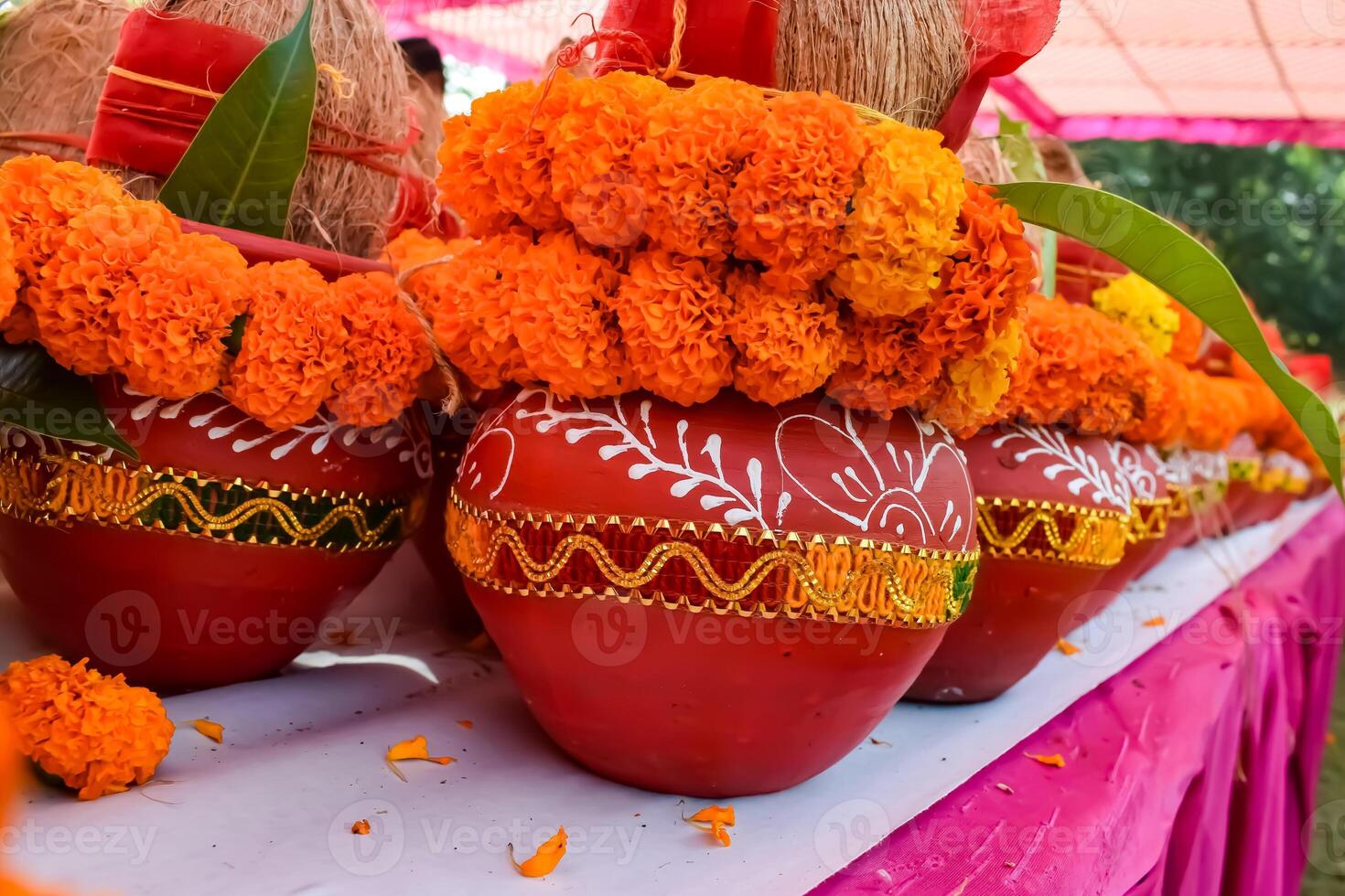 Kalash with coconut and mango leaf with floral decoration earthen pots containing sacred water. Kalash for hindu puja during Jagannath Temple Mangal Kalash Yatra, front view, closeup photo