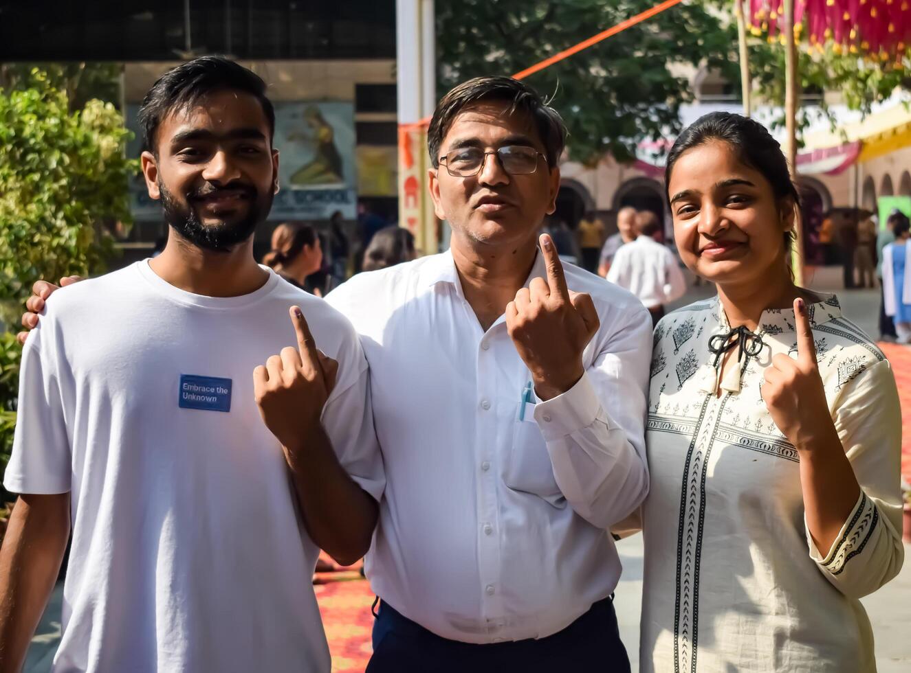 New Delhi, India - May 25 2024 - Unidentified people showing their ink-marked fingers after casting votes in front of polling booth of east Delhi area for general Lok Sabha Elections 2024 photo