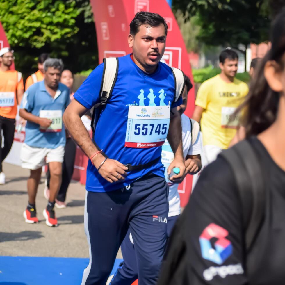 New Delhi, India - July 15 2024 - Vedanta Delhi Half Marathon race after covid in which marathon participants about to cross the finish line, Delhi Half Marathon 2023 photo