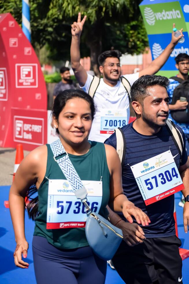 New Delhi, India - July 15 2024 - Vedanta Delhi Half Marathon race after covid in which marathon participants about to cross the finish line, Delhi Half Marathon 2023 photo