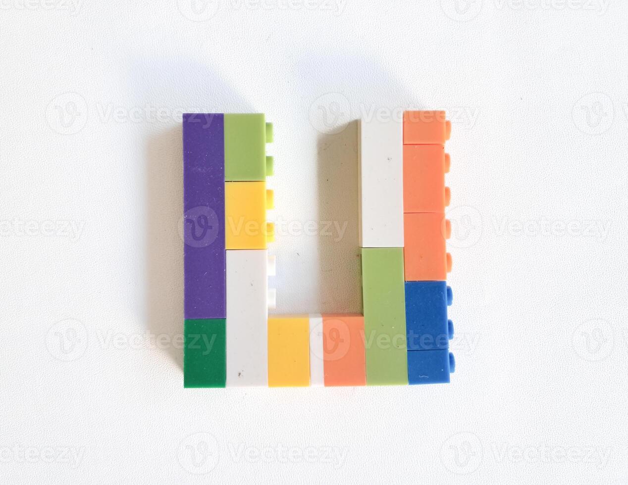 letter made from children toys on white background photo