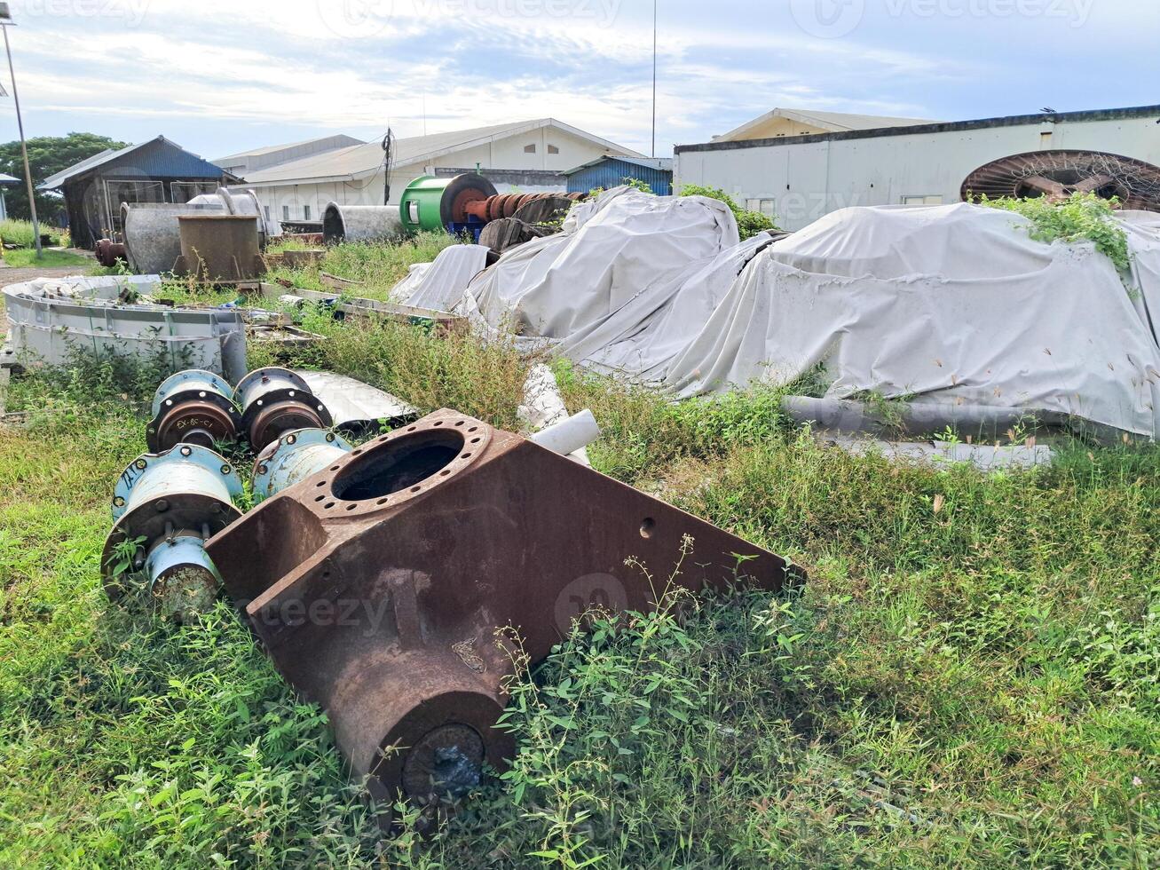 A collection of spare parts for steam power plants that are stacked because they are no longer used photo