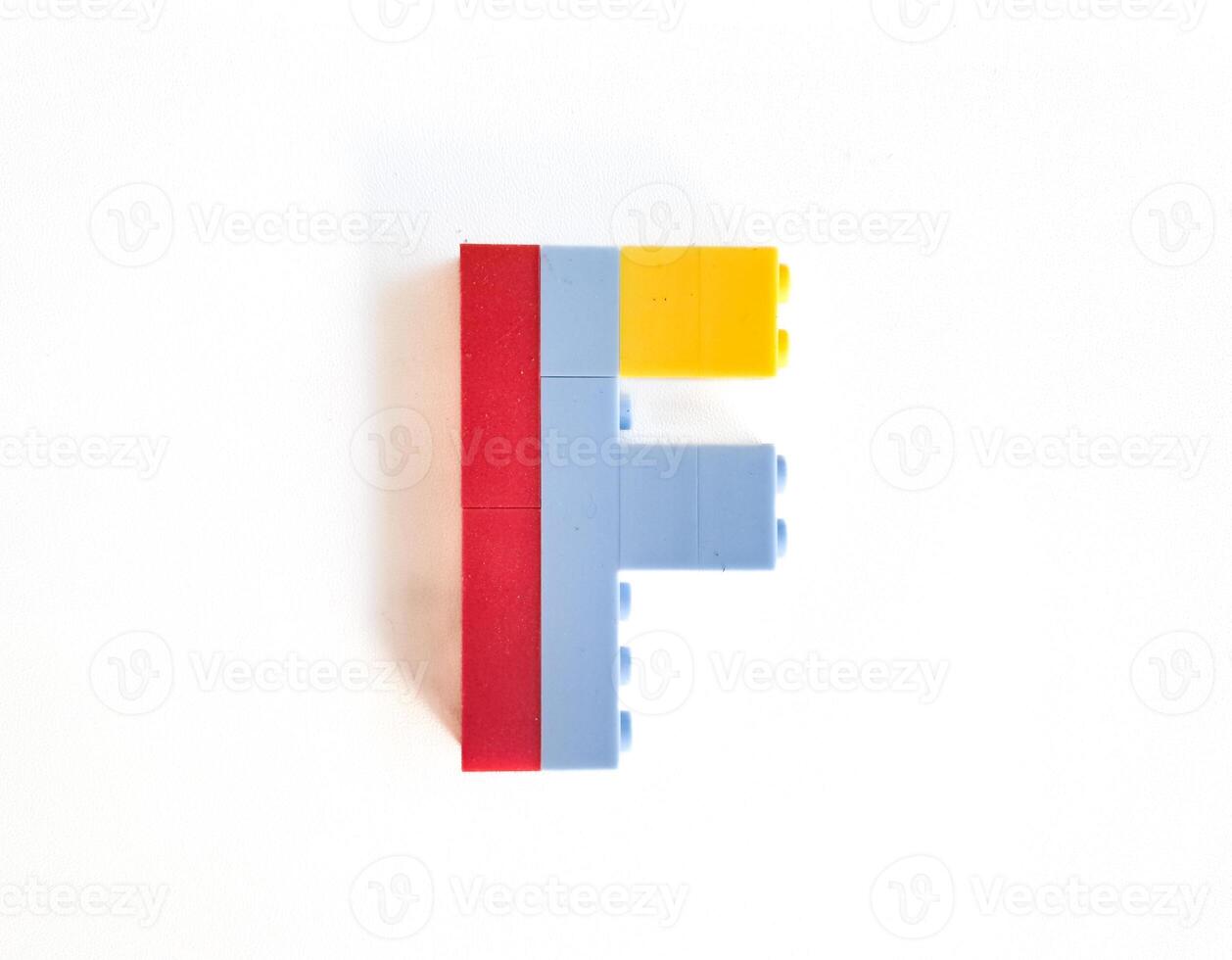 letter made from children toys on white background photo