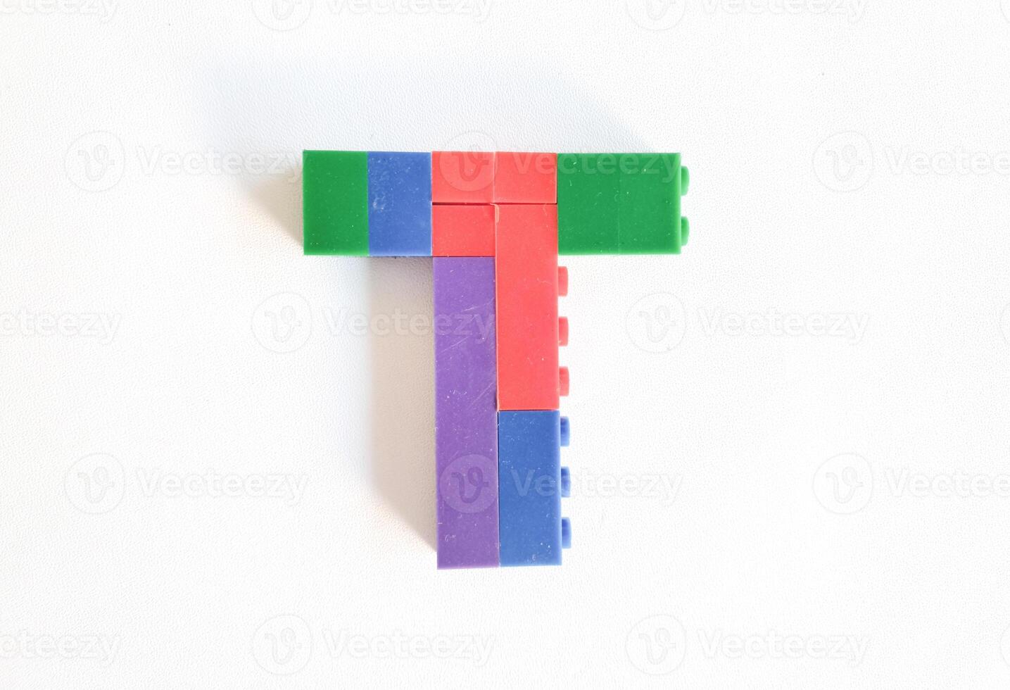 letter made from children toys on white background photo