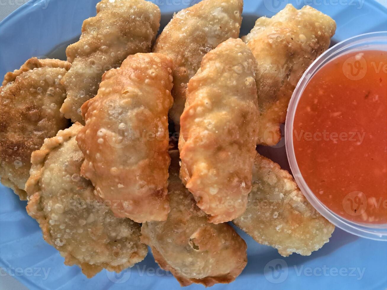 Food called Jalankote, typical of Makassar, South Sulawesi with a white background and delicious chili sauce photo