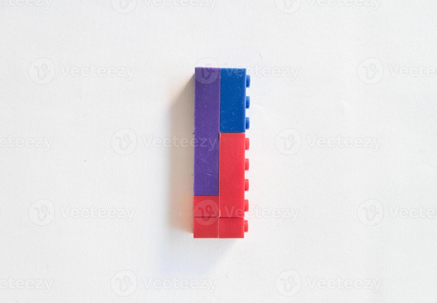 letter made from children toys on white background photo