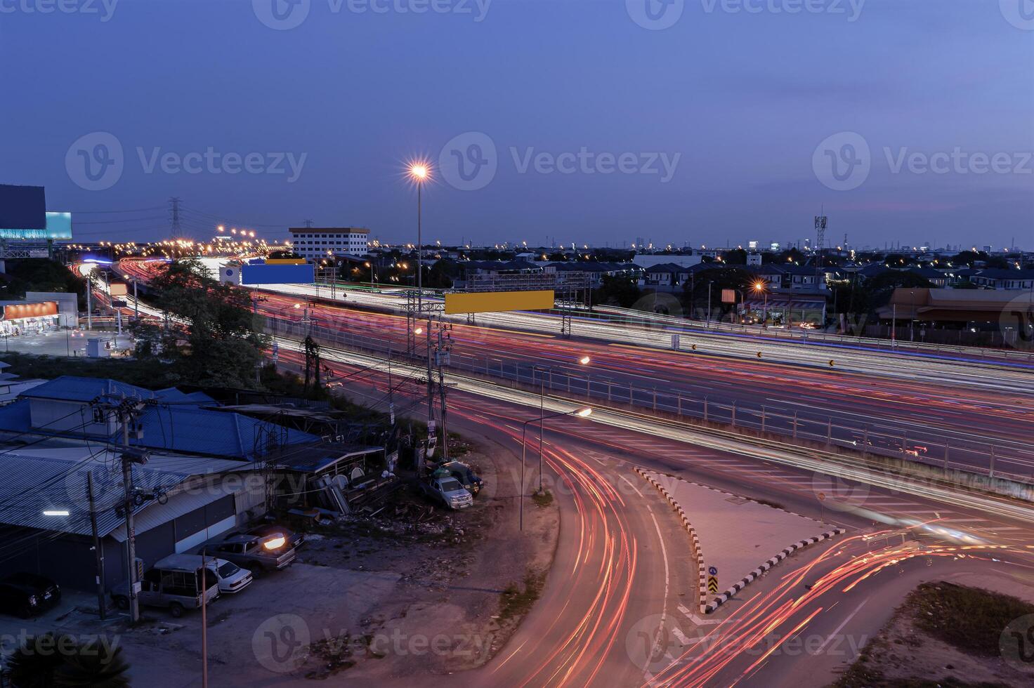 Long exposure shot of traffic while traveling at night on a motorway in Thailand. Abstract animated curved city road with neon light motion effect applied. photo