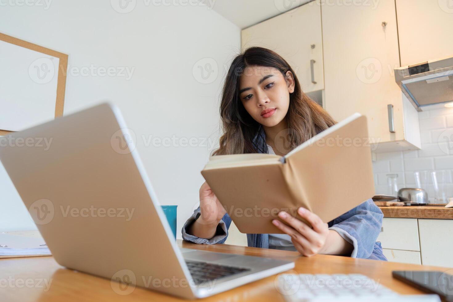 Woman Working from Home in Dining Room with Laptop and Notebook, Remote Work Concept, Modern Home Office Setup photo