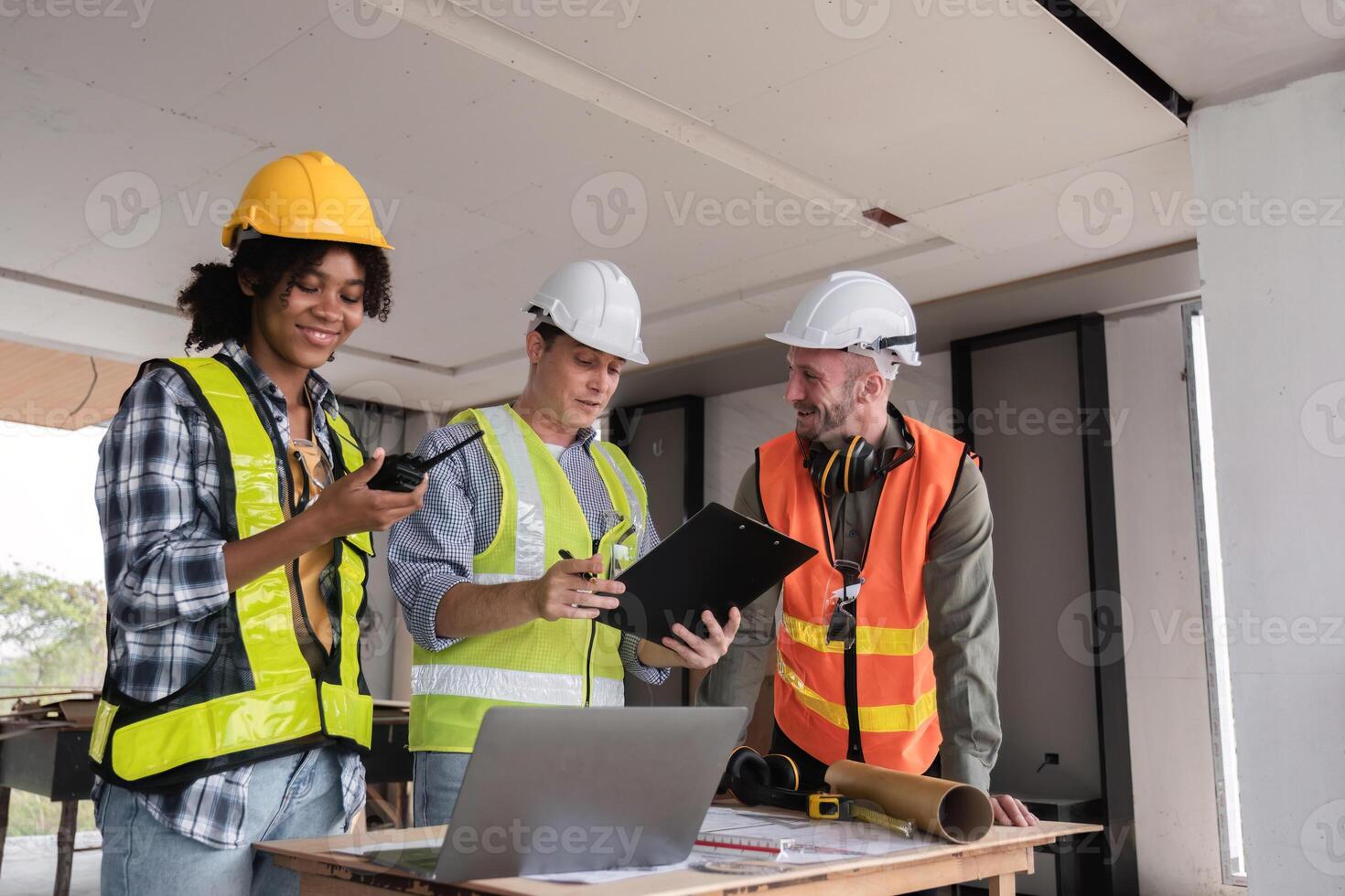 Engineering Team Collaborates on Work Plan at Construction Site with Safety Gear and Equipment photo