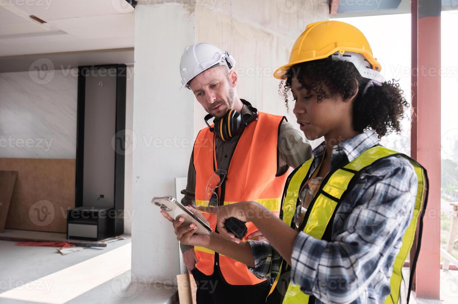 Engineering Team Collaborates on Construction Site Work Plan with Digital Tools and Safety Gear photo