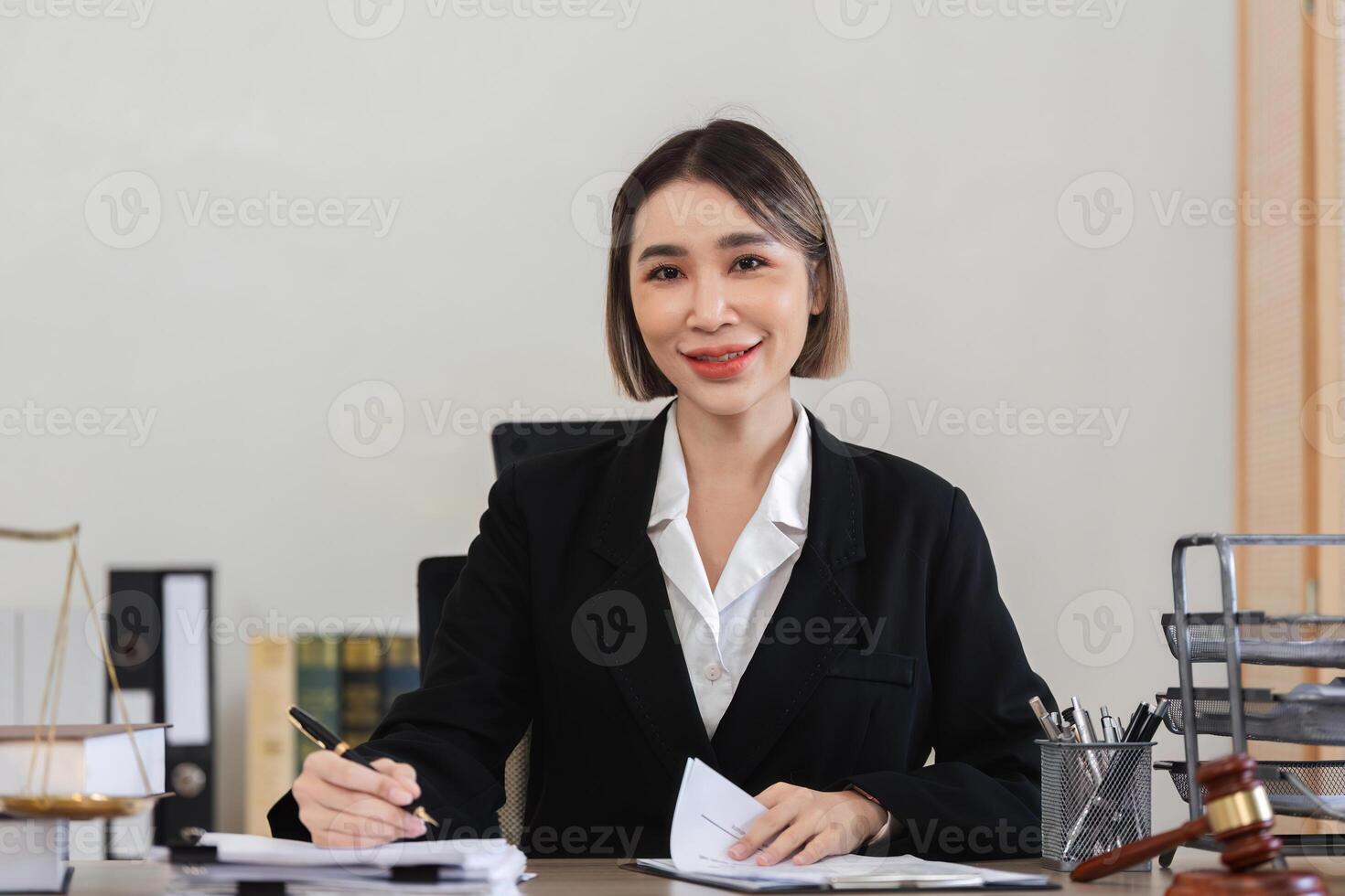 Professional Female Lawyer Reviewing Legal Contract Documents in Office Setting for Lawsuit Preparation photo