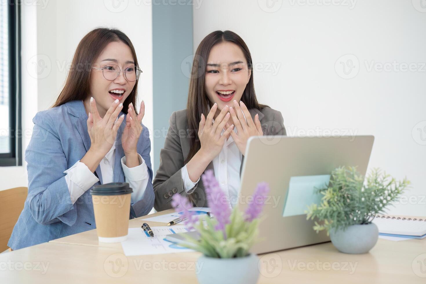 Two Female Accountant Collaborating on Financial Graphs and Data Analysis in a Modern Office Setting photo