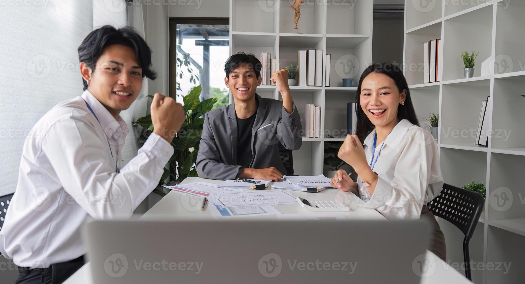 Dynamic and Successful Business Team Celebrating Achievement in Modern Office Environment photo