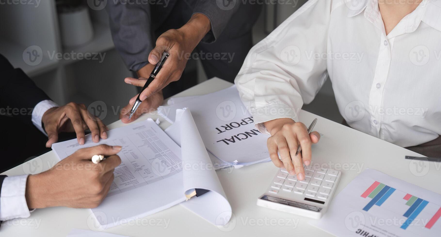 Business Team Collaborating on Financial Reports and Ideas in a Modern Office Setting photo
