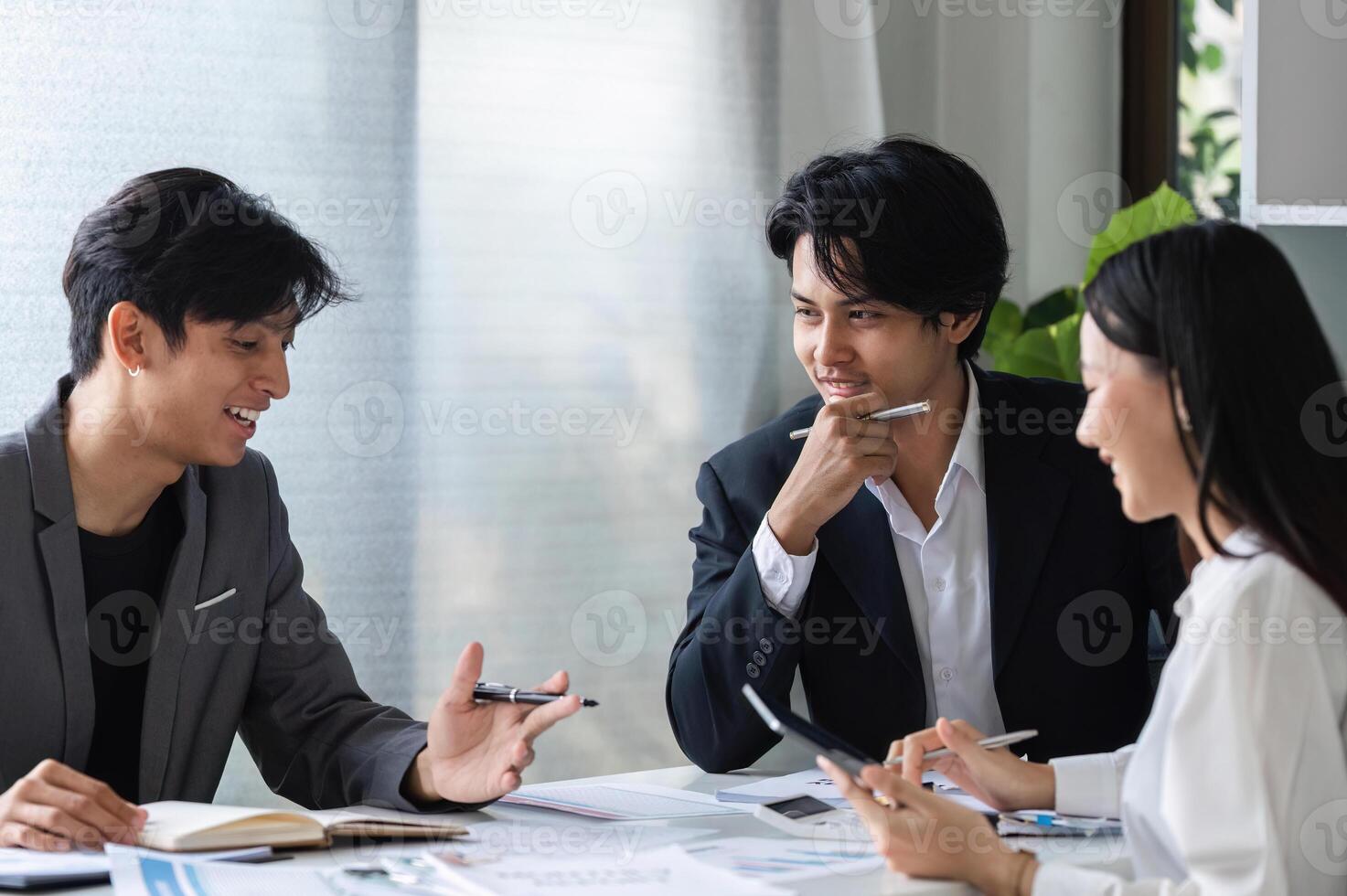 Diverse Team of Business Professionals Collaborating and Sharing Ideas in a Modern Office Setting photo