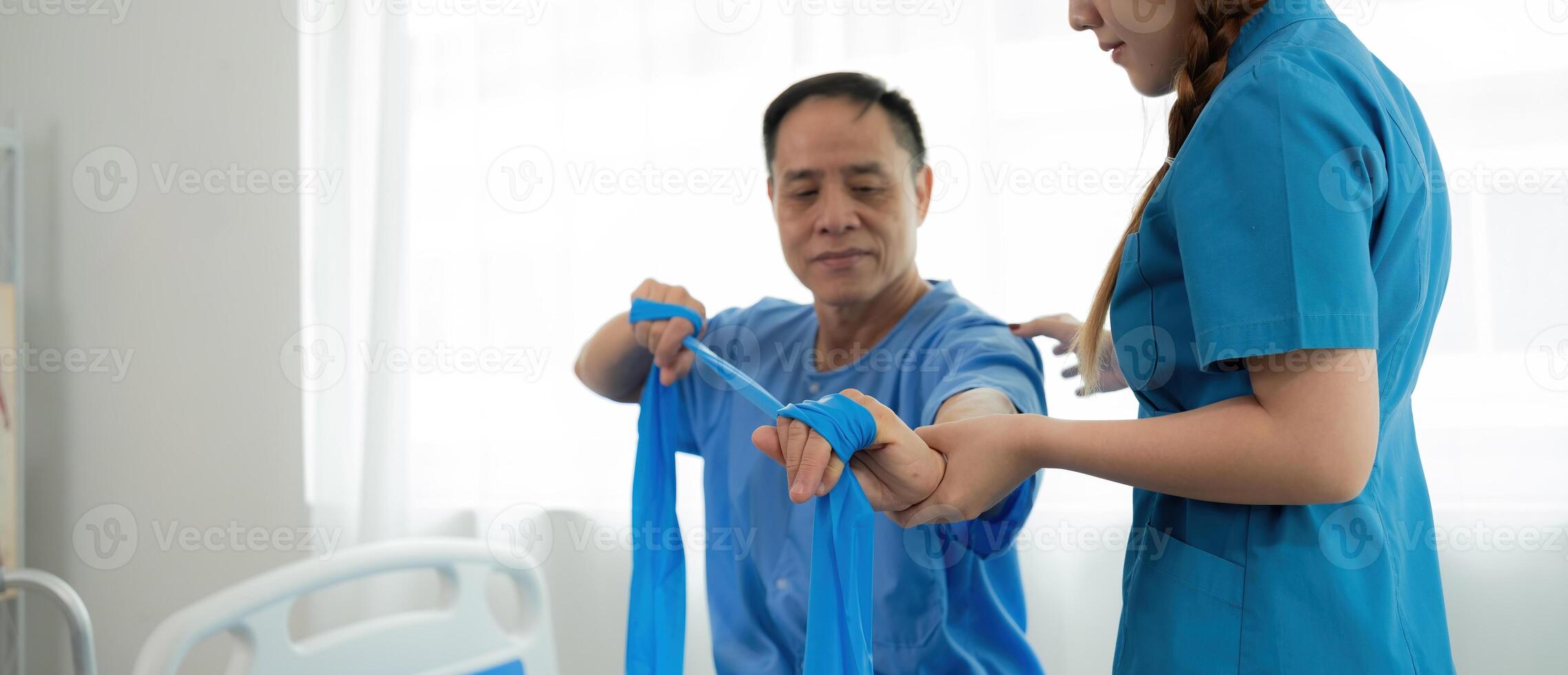 Elderly Patient Receiving Physical Therapy from Young Female Therapist in Medical Facility photo