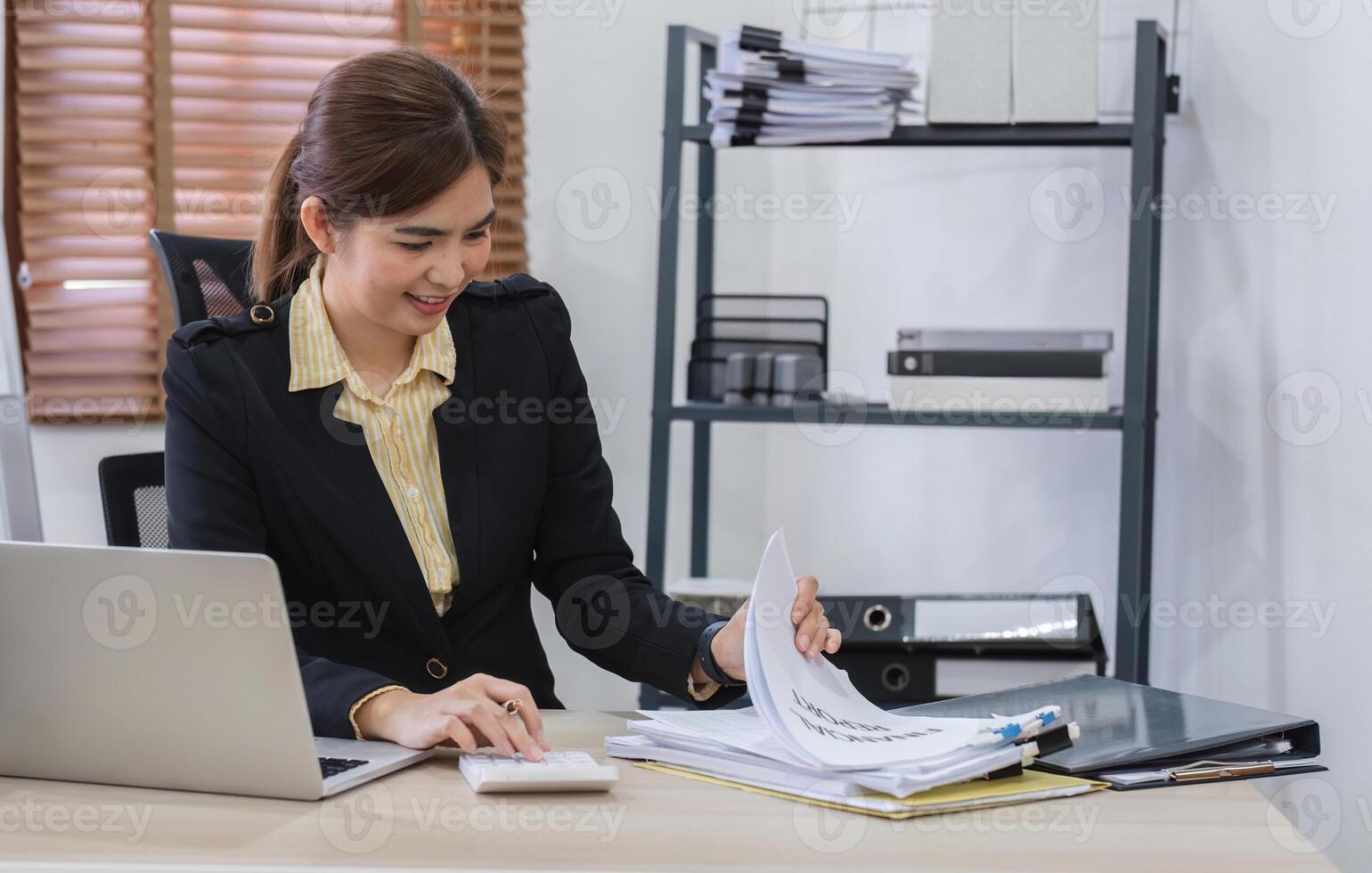 Business Woman Working on Document with Laptop in Modern Office Setting, Professional and Focused on Task photo