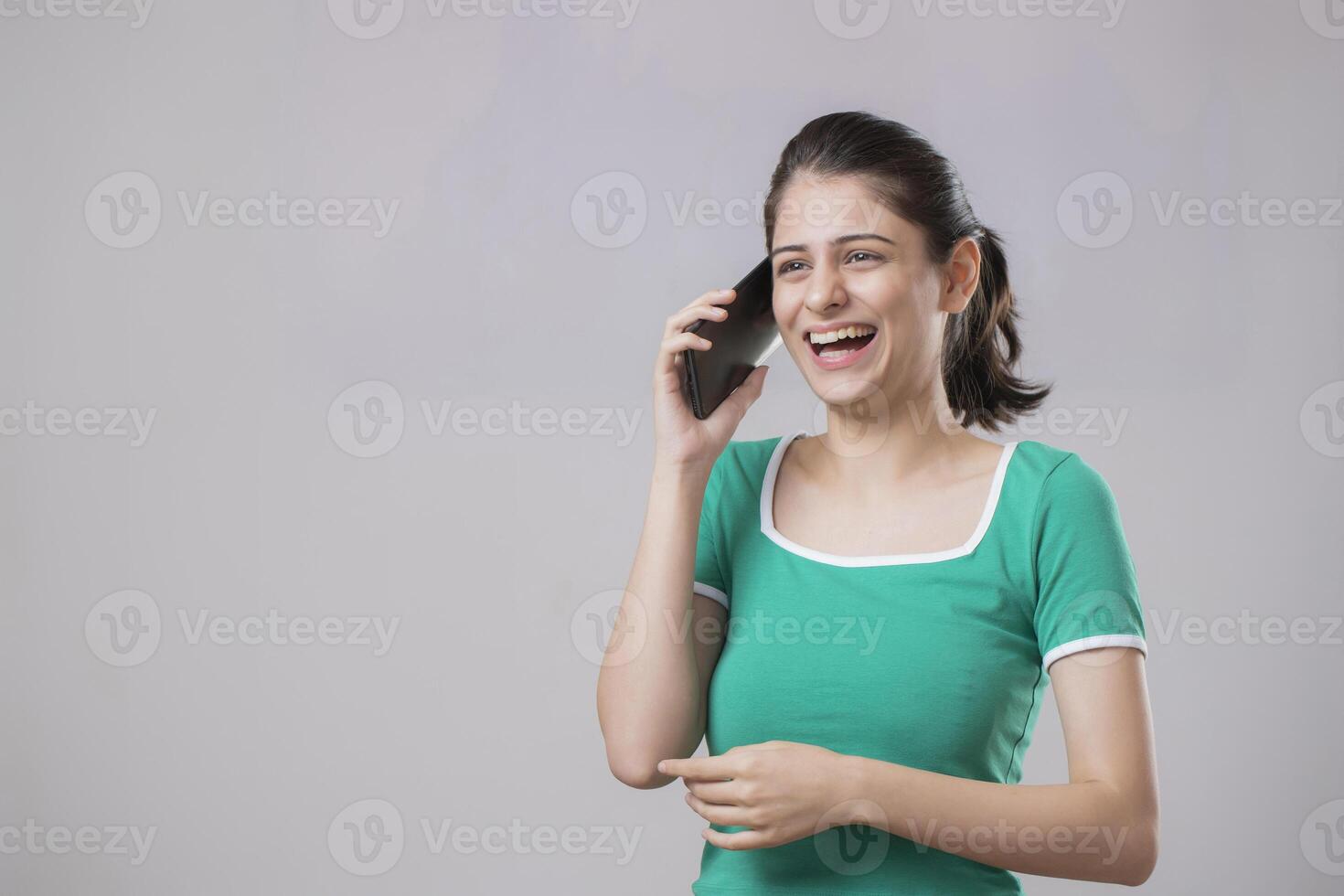 Innocent Model Laughing While Talking On Phone photo