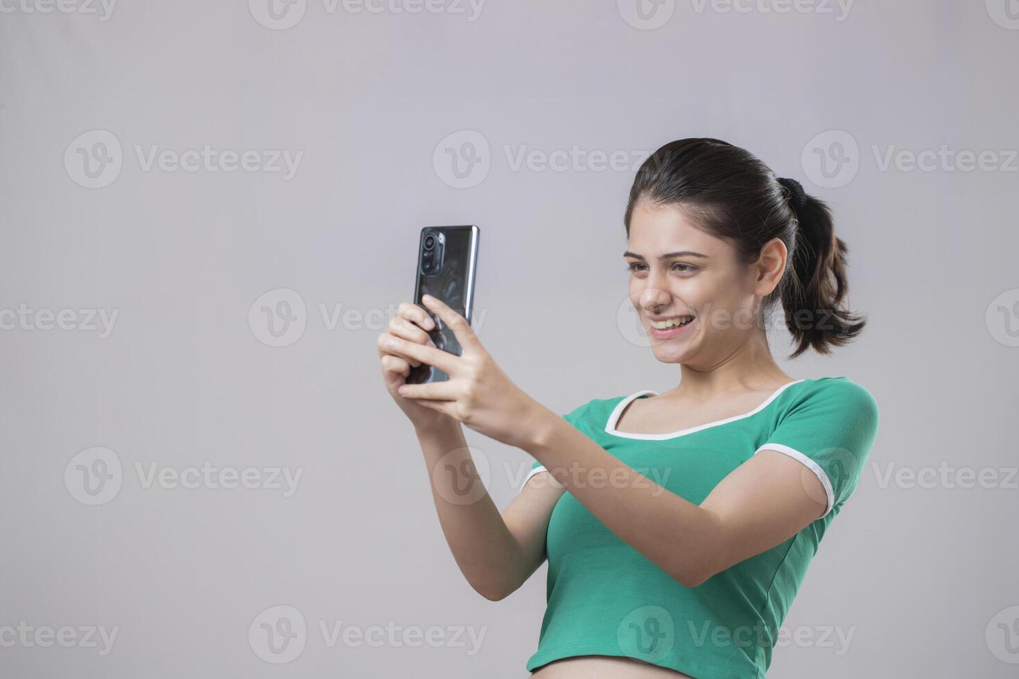 Innocent Young Woman Talking To Someone On Her Phone photo