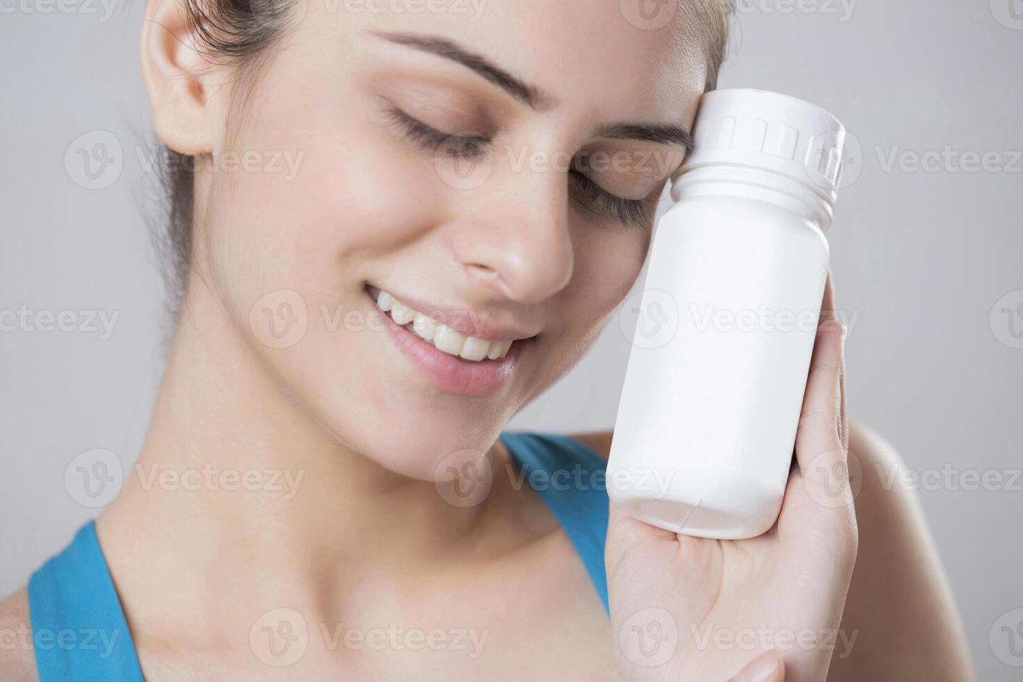 Model Close Up Shot Holding Vitamin Capsule Bottle In Hand photo