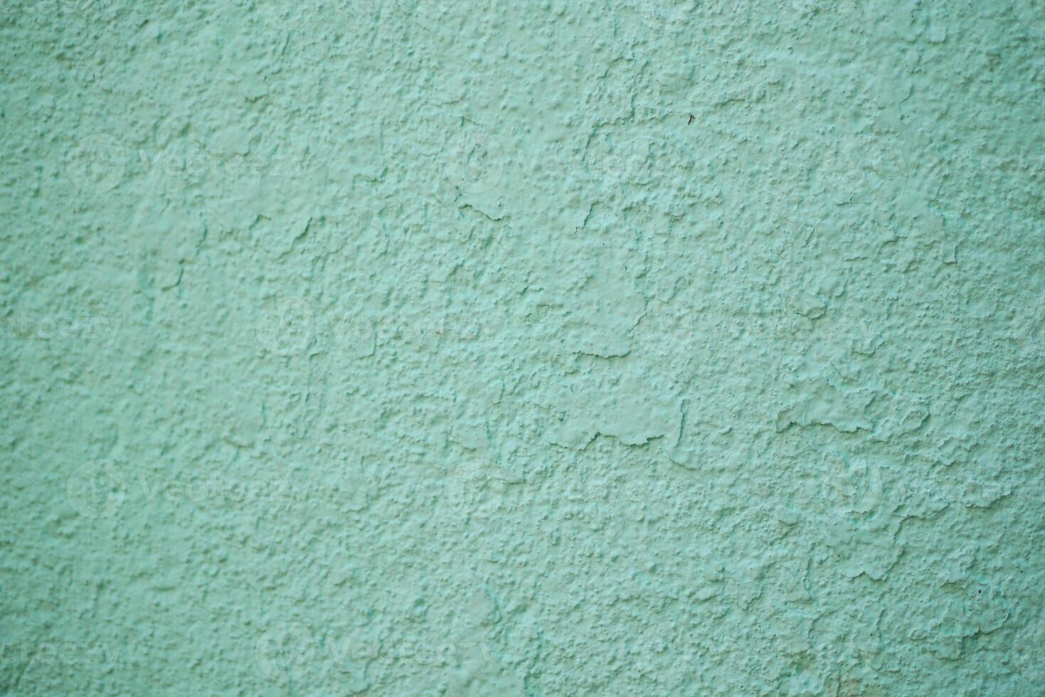 An aesthetically pleasing textured mint green wall surface featuring subtle, intricate patterns photo