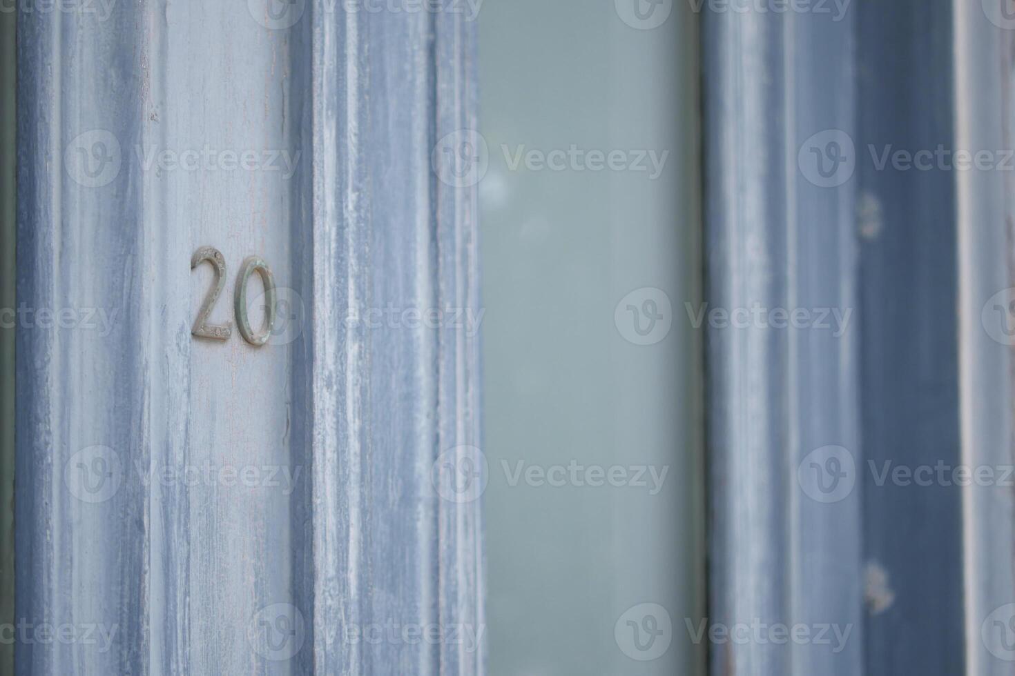 A closeup view of a beautifully designed Blue Door featuring the Number 20 prominently displayed photo