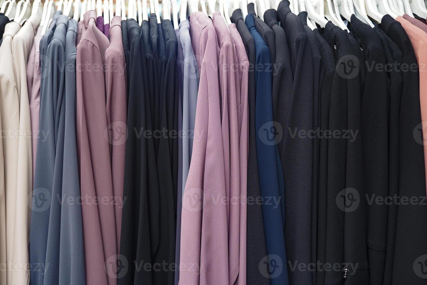 A Beautifully Colorful Collection of Various Womens Apparel Displayed Elegantly on Racks photo
