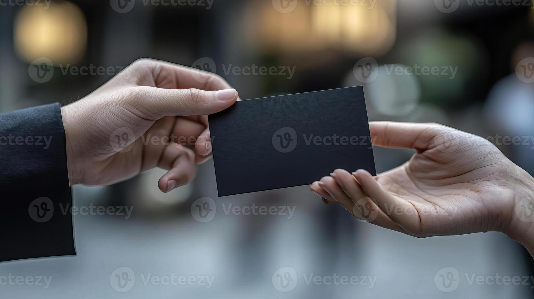a photo of someone handing another person a black business card