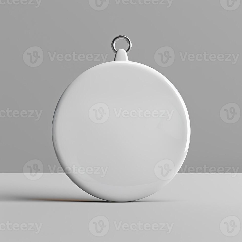 A white circle with a metal loop at the top for hanging. photo