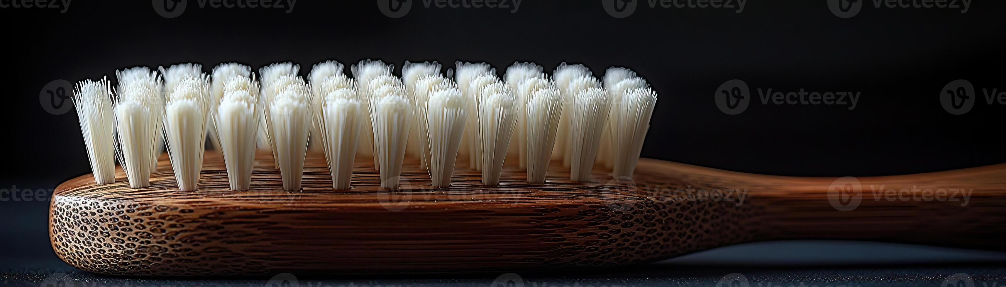 A handcrafted wooden brush with white bristles, contrasted against a dark, moody background, capturing a sense of timeless utility and elegance photo