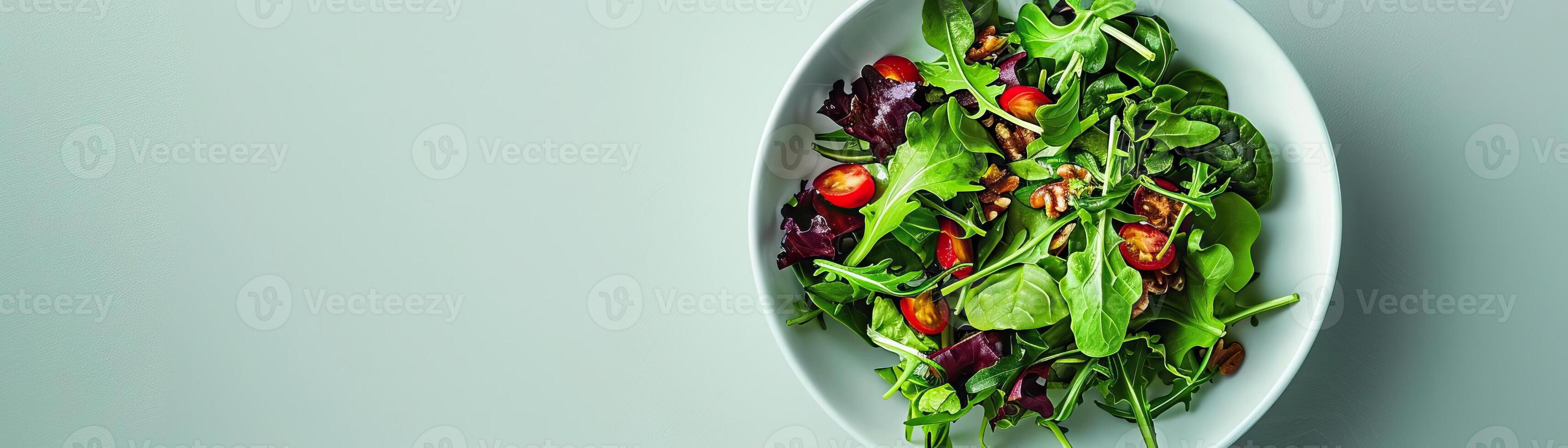A zen-like setting with a simple salad of mixed greens and nuts, centered on a minimalist white table, inviting focus and simplicity, wide space for copy on one side. photo